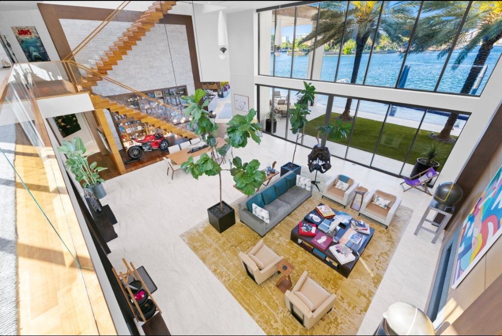 Grand staircase looking out onto expansive living areas and curated collections at 84 Isla Bahia
